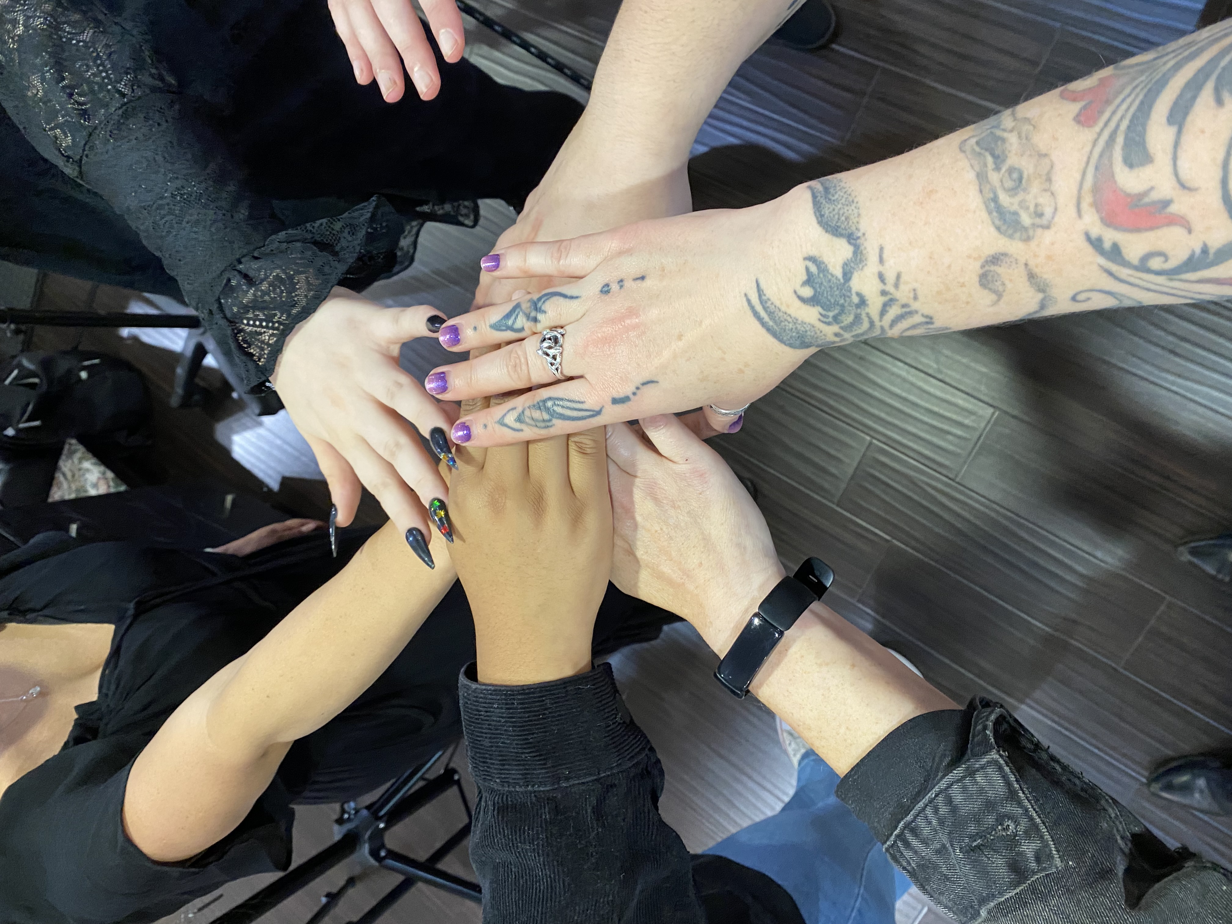 seven hands together with many differnt sizes, shapes, colors, nail lengths, tattoos, etc.